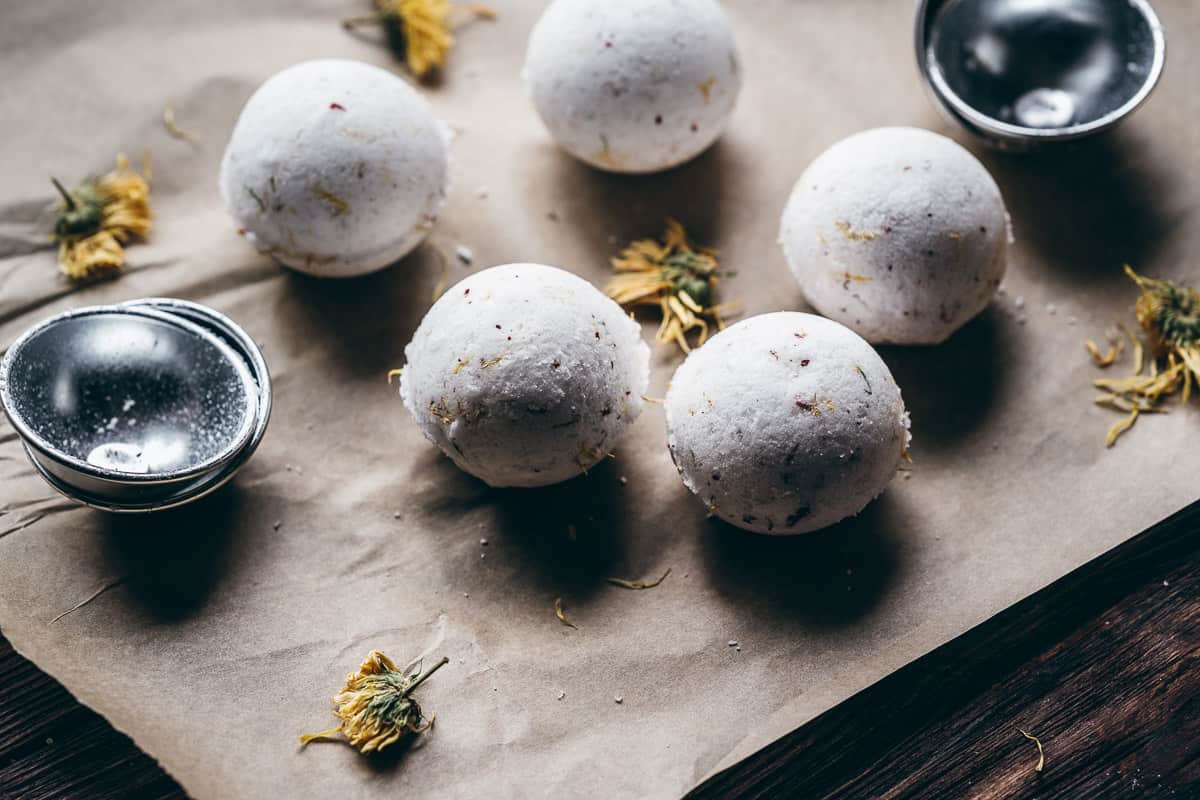 white bath bombs rest on brown parchment paper