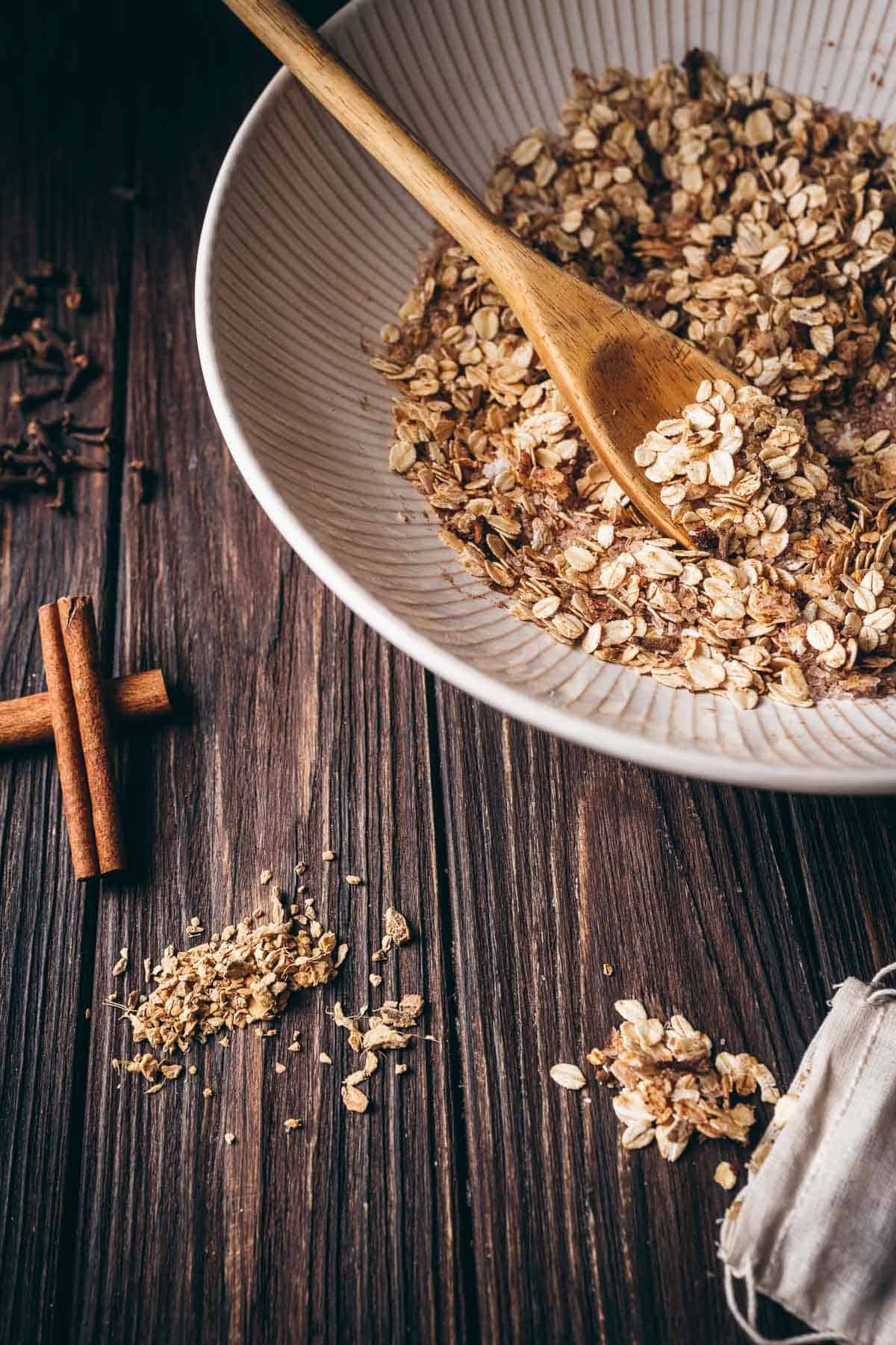 A large white ceramic bowl filled with rolled oats and spices.