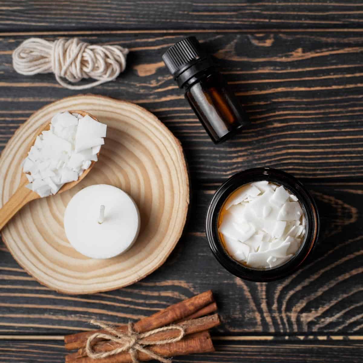 A soy wax candle kit resting on a dark wooden table.