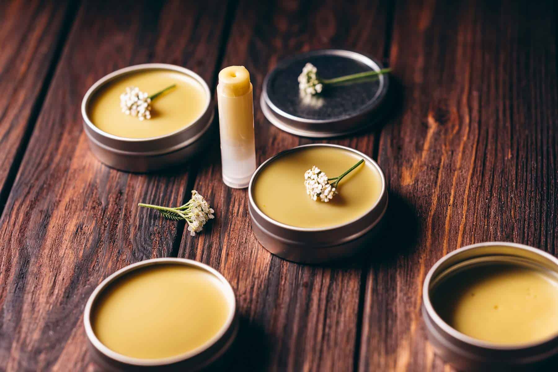 Silver salve tins filled with a yellow wax.