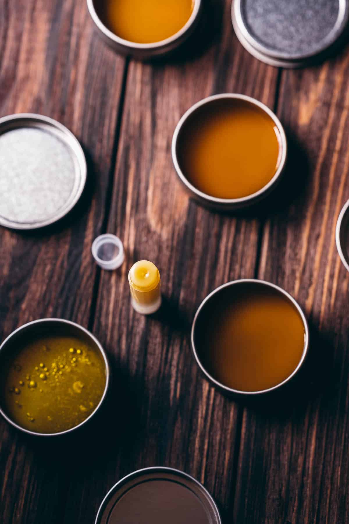 Open silver tins filled with a yellow liquid.