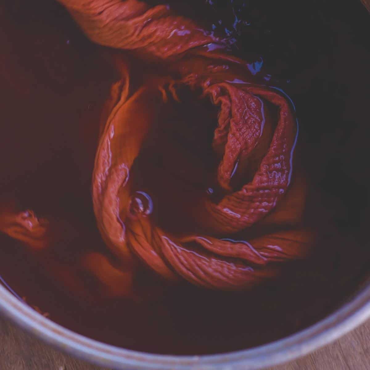 Fabric resting in a natural dye pot.