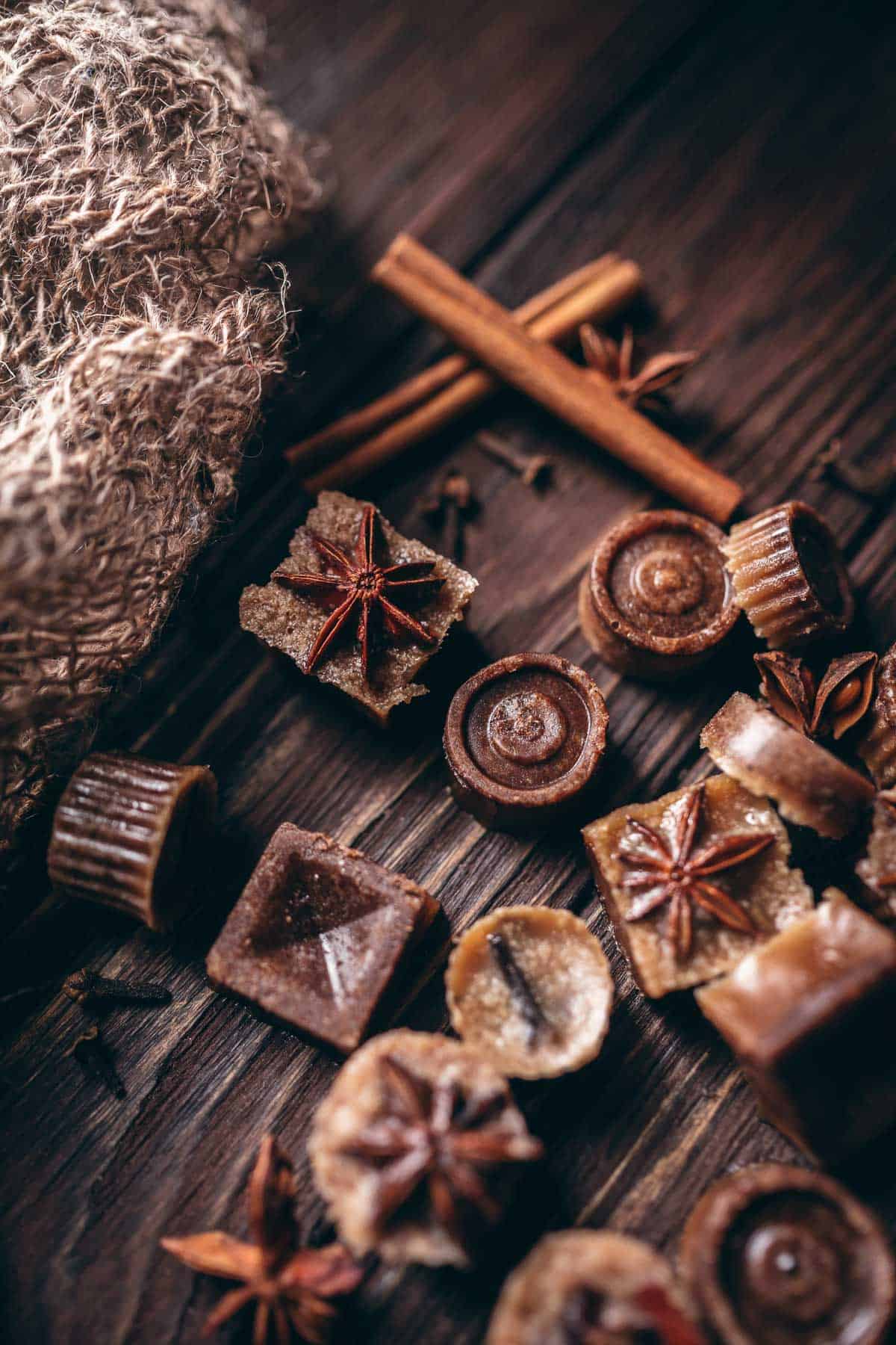 Homemade bath melts resting on a dark wooden tabletop.