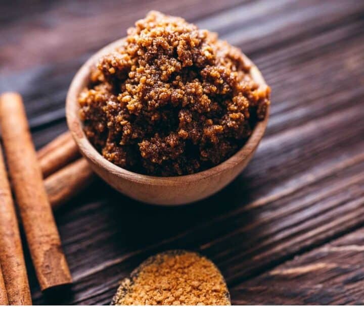 Cinnamon and sugar lip scrub on a wooden table.