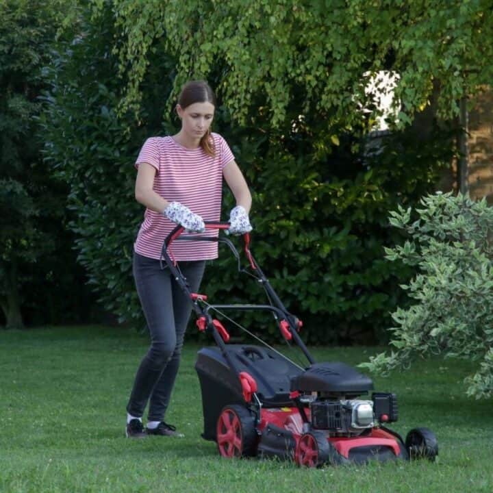A woman mowing the grass.