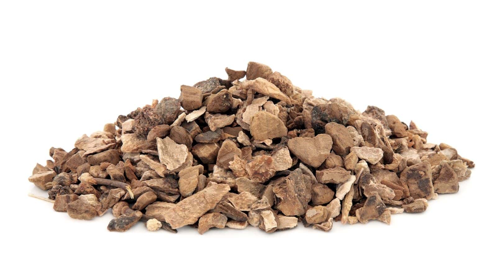 A pile of dried and chopped brown root pieces on a white background.