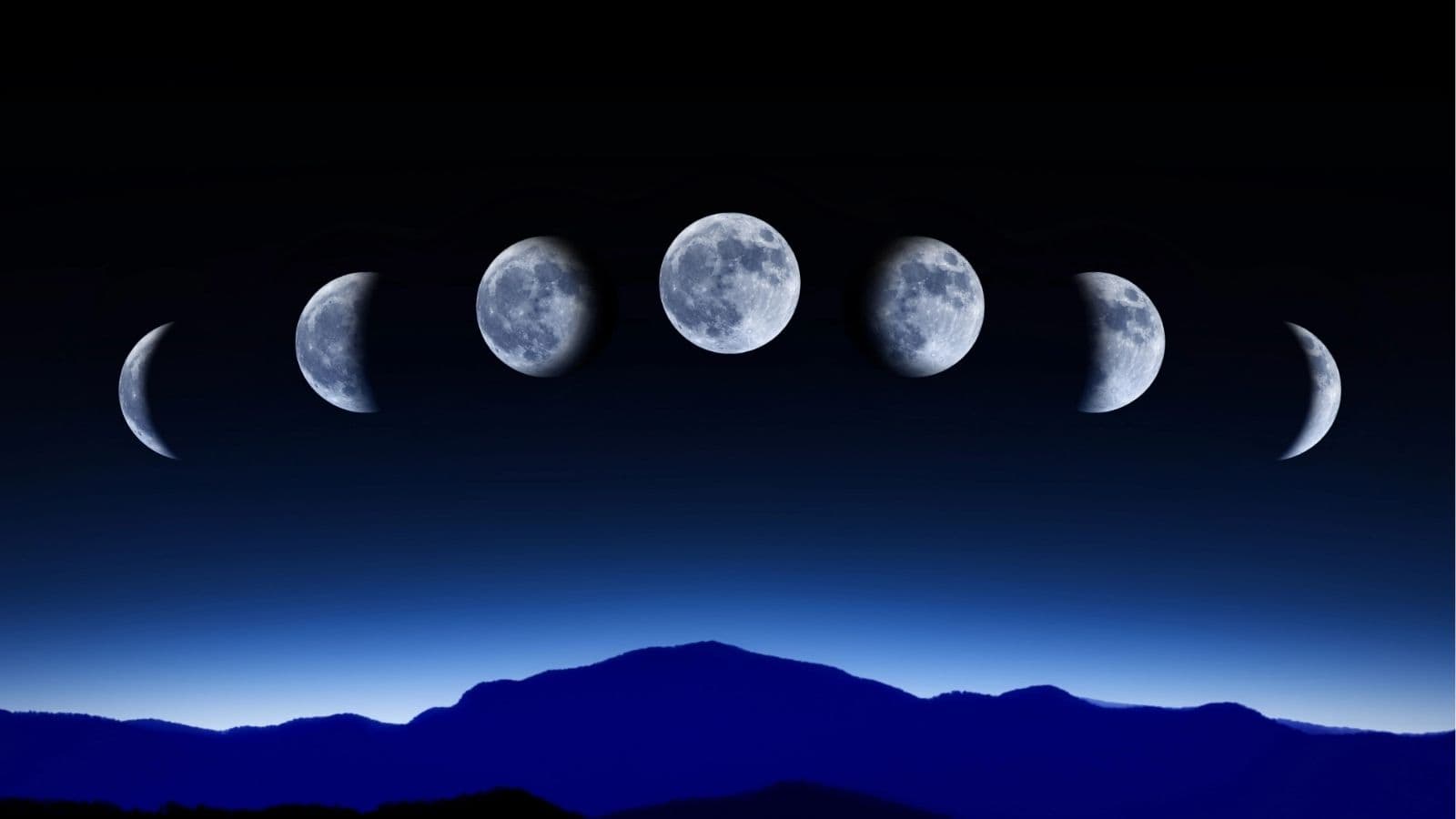 Phases of the moon shown in sequence above a dark blue mountain landscape at night.